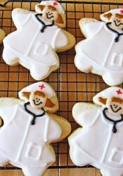 Overhead view of sugar cookies decorated as nurses on a cooling rack