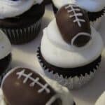Overhead view of Chocolate Cupcakes topped with frosting and football-themed truffles