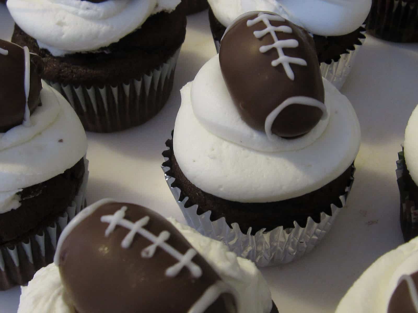 Overhead view of Chocolate Cupcakes topped with frosting and football-themed truffles