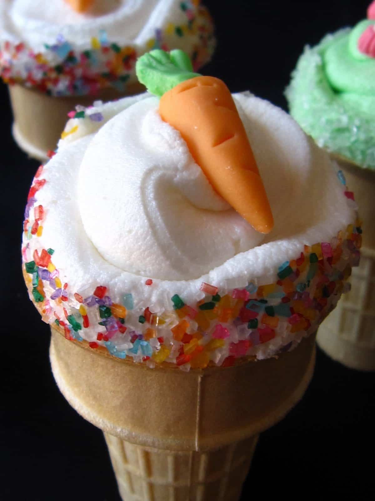 Overhead view of a cupcake in an ice cream cone with a carrot decoration on top