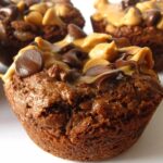Close-up of individual brownie cups topped with peanut butter and chocolate