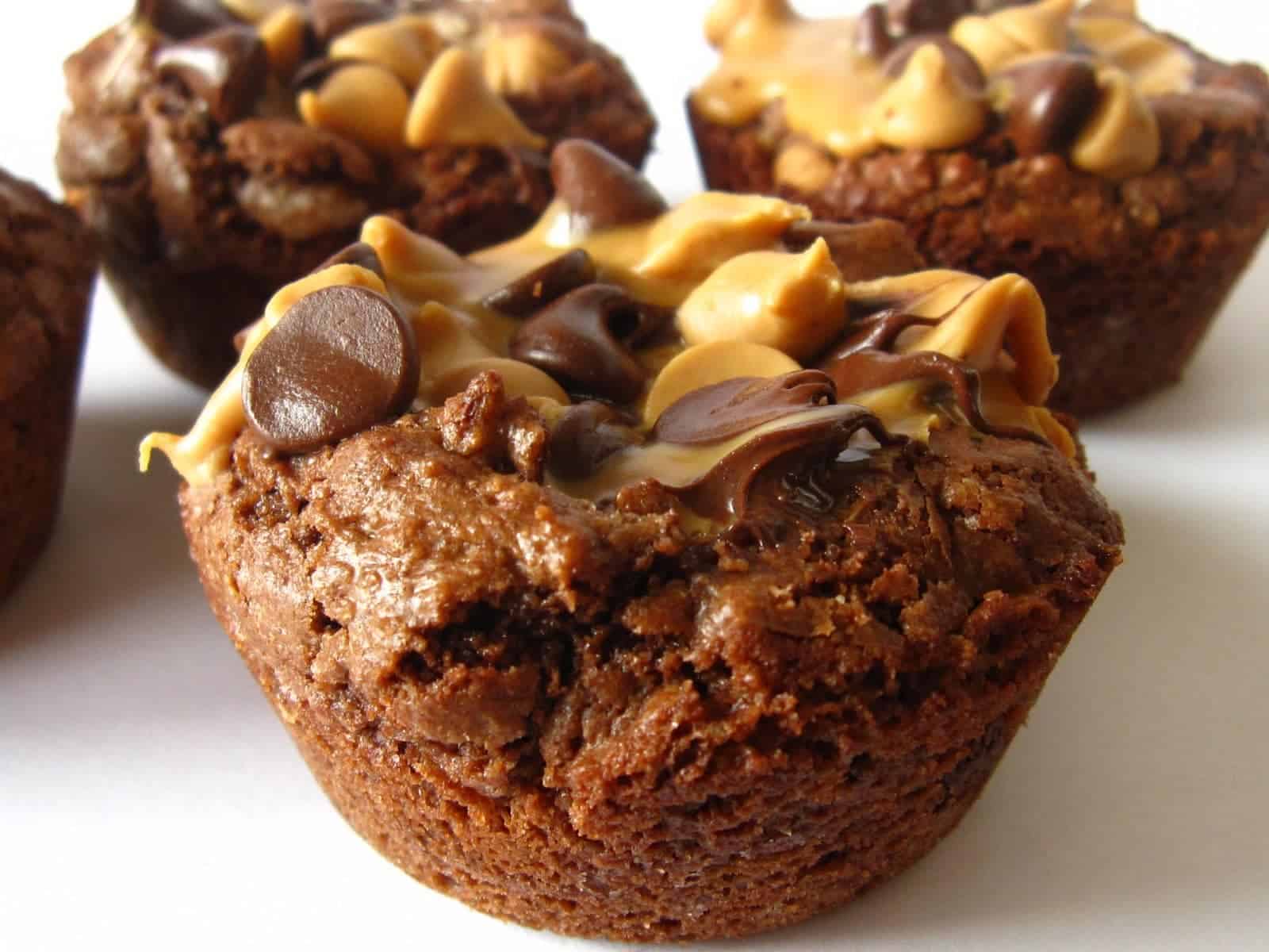 Close-up of individual brownie cups topped with peanut butter and chocolate