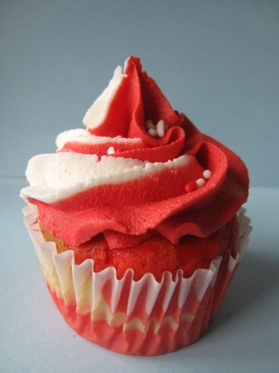 Close-up of a red and white swirled cupcake with red and white frosting