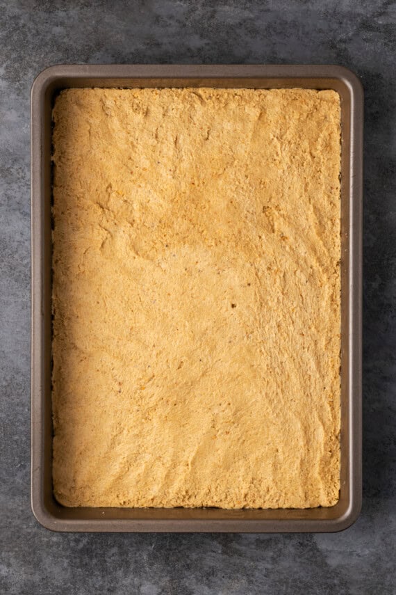 Peanut butter mixture pressed into a 9x13-inch baking pan.