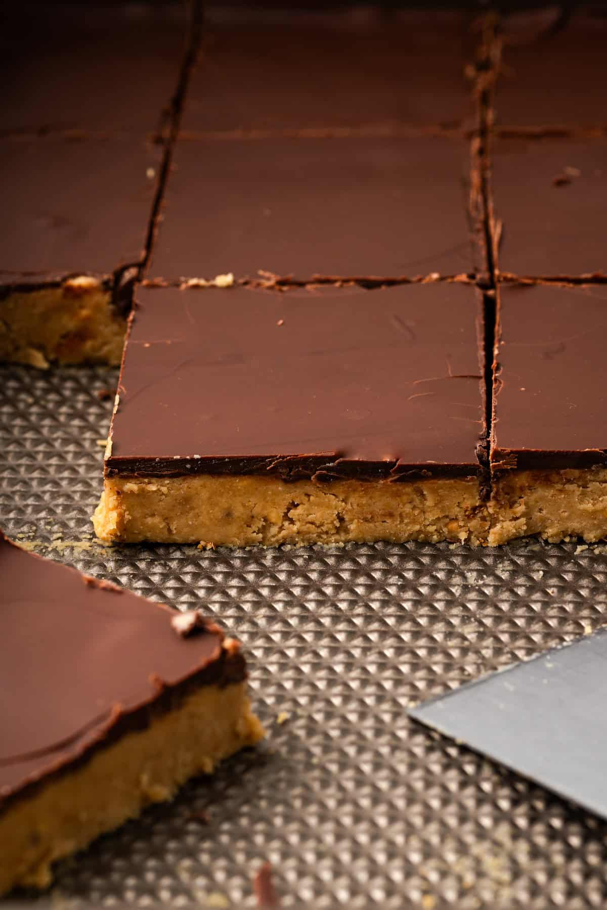 Close up of chocolate peanut butter bars in a baking pan.