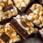 Close up of smores brownies arranged on a parchment-lined board.
