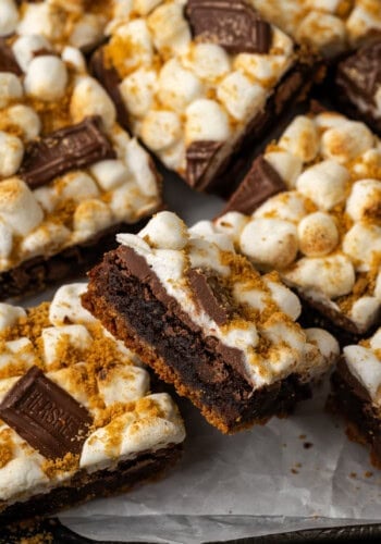 Close up of smores brownies arranged on a parchment-lined board.
