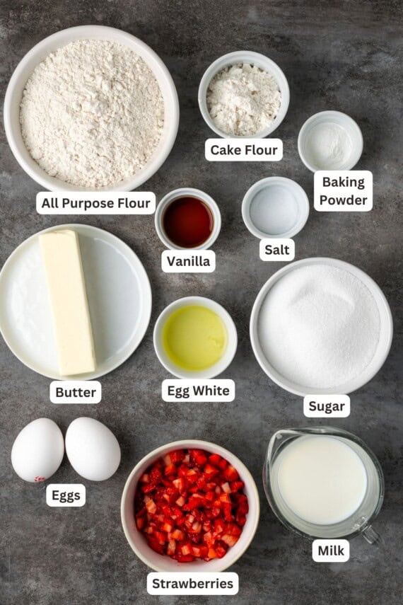 Ingredients for strawberry cupcakes with text labels overlaying each ingredient.