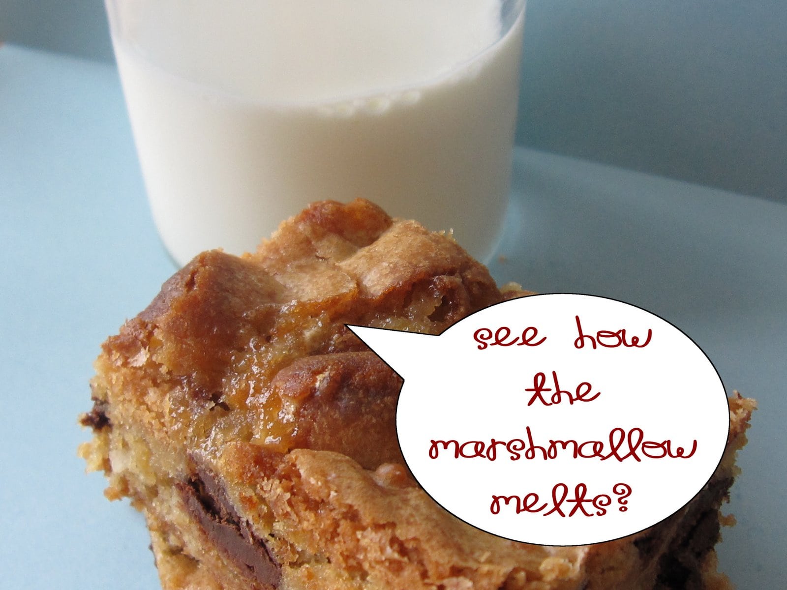 A blondie with a glass of milk and a word bubble "See how the marshmallow melts?"