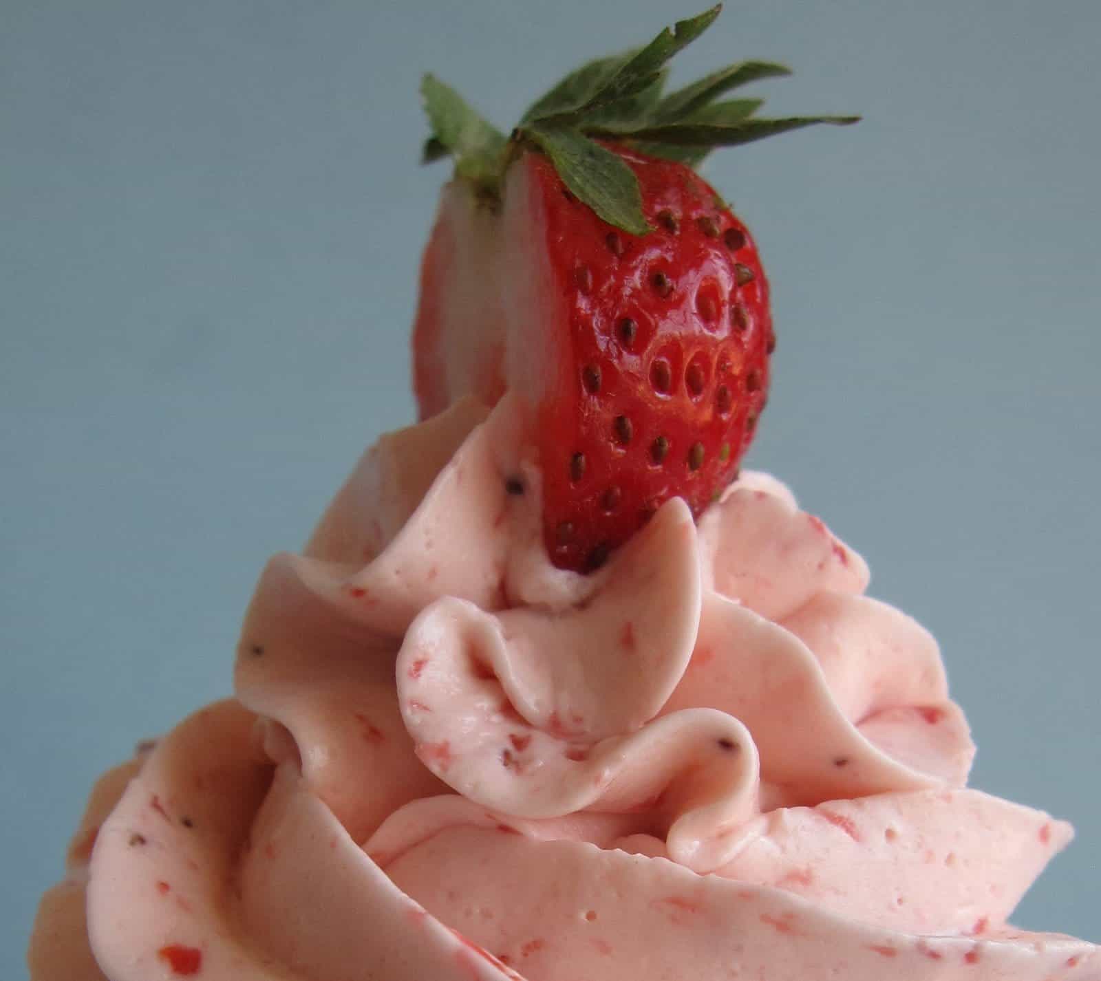 Close-up of strawberry frosting with a strawberry on top