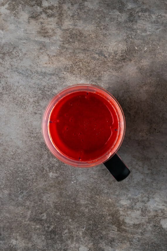 Pureed strawberries inside a blender.