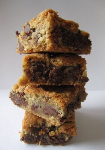 A stack of chocolate chip cookie bars on a white surface