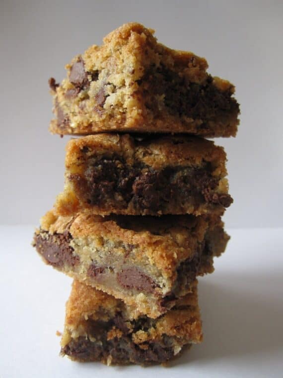A stack of chocolate chip cookie bars on a white surface