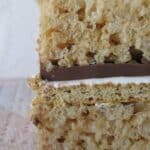 Side view of a S'Mores Krispie Treat with chocolate and marshmallow in the middle