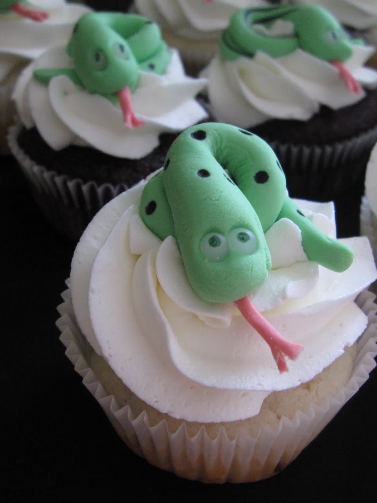 Overhead view of cupcakes with fondant snake toppers