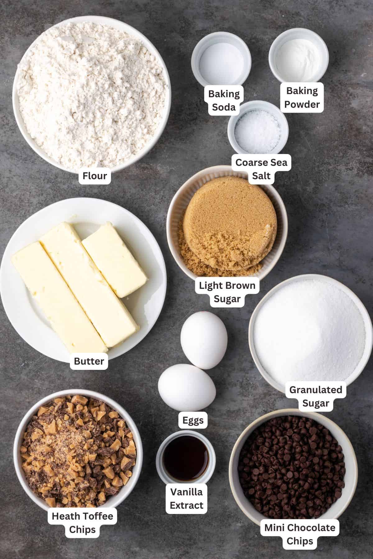 Homemade toffee chocolate chip cookies ingredients with text labels overlaying each ingredient.