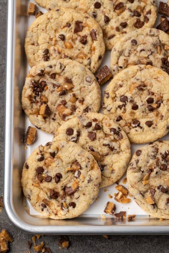 Overhead view of toffee chocolate chip cookies on a baking tray.