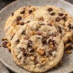 Close up of toffee chocolate chip cookies on a stoneware plate.