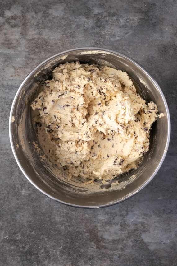 Toffee chocolate chip cookie dough in a metal bowl.