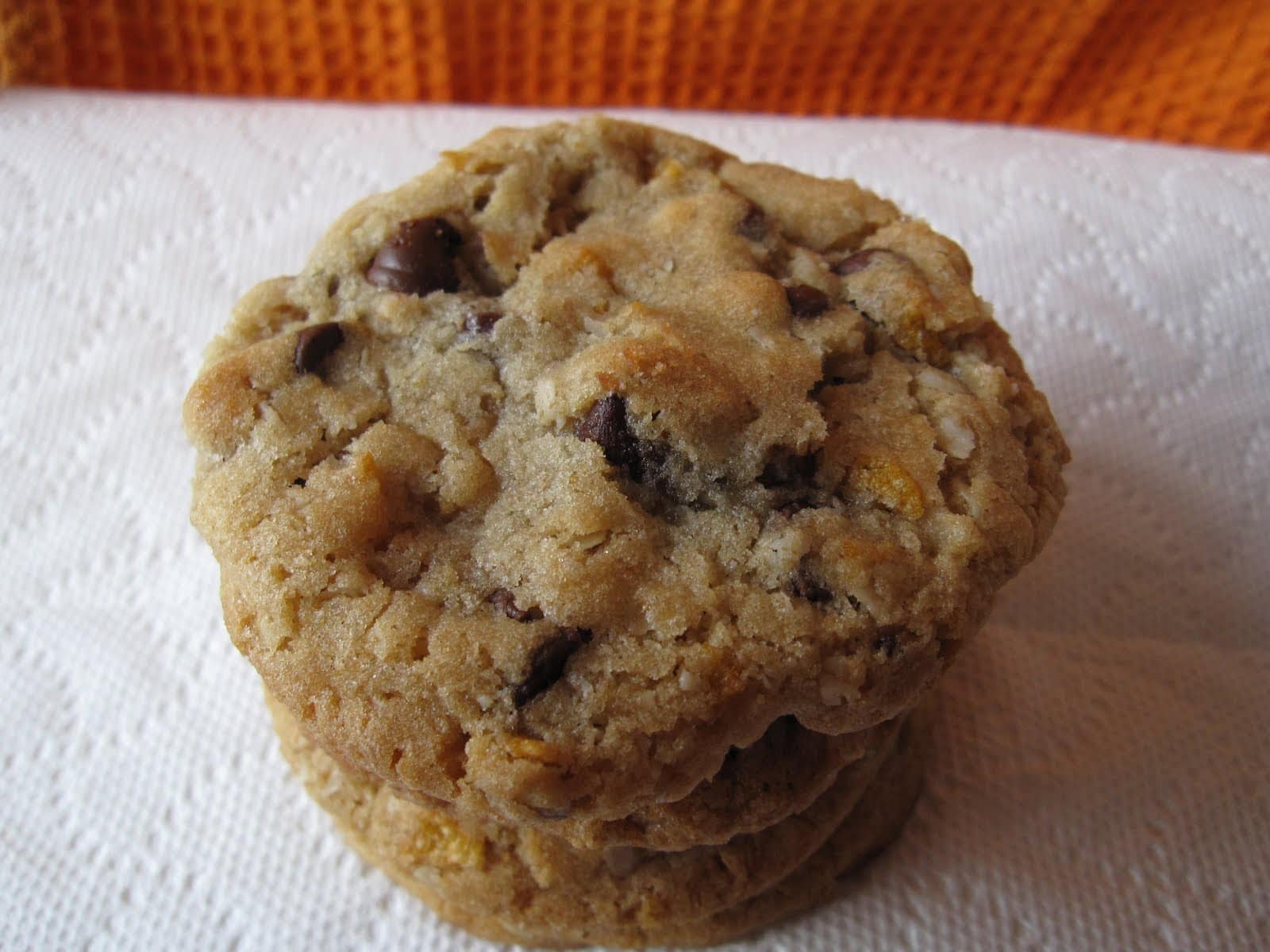 A stack of chocolate chip cookies on a napkin