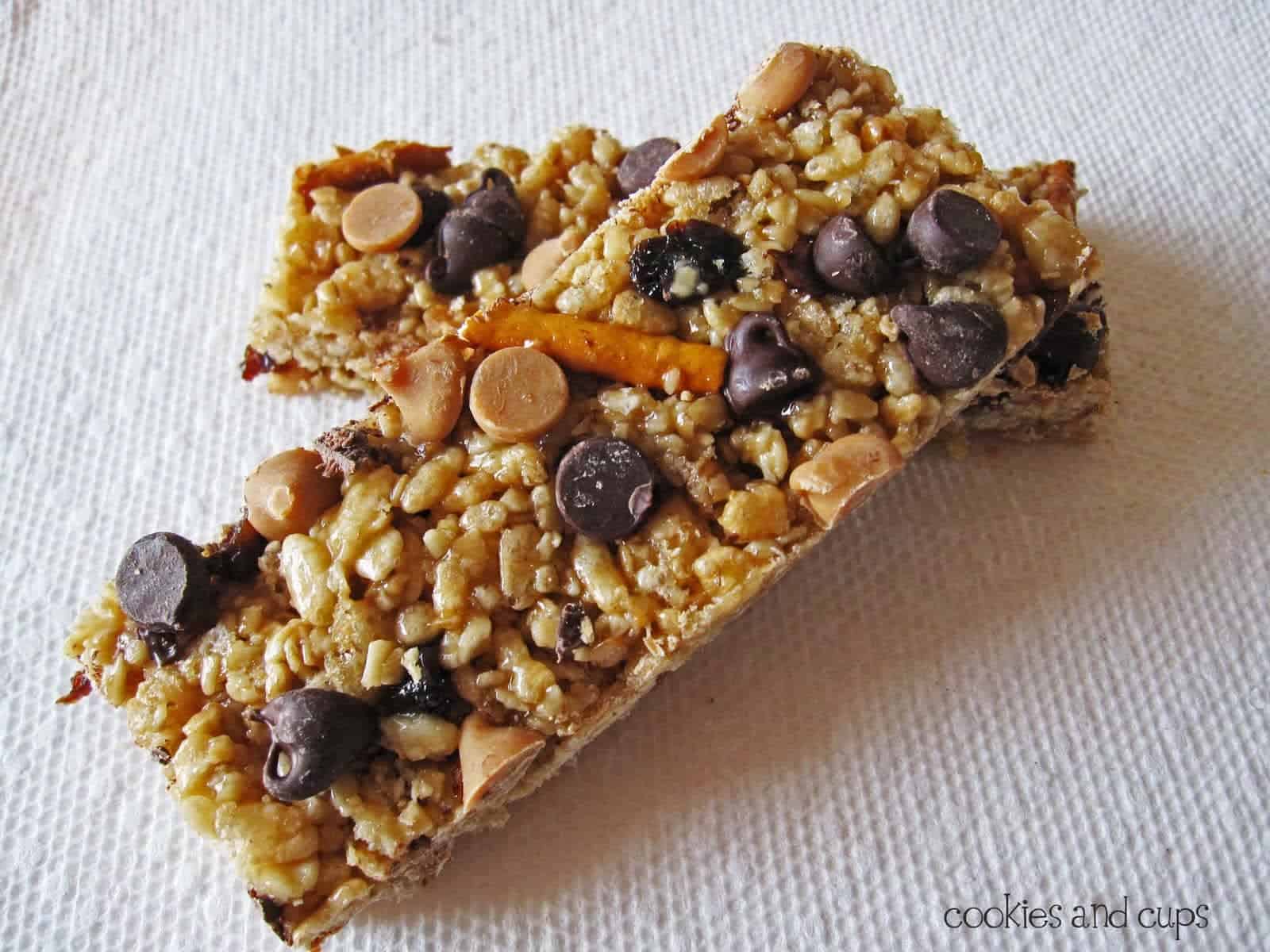 Overhead view of two homemade granola bars with chocolate chips and pretzels