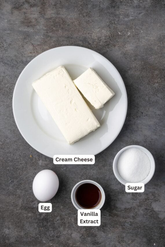 Cheesecake ingredients with text labels overlaying each ingredient.