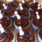 Close-up of chocolate cupcakes with bowling pin decorations