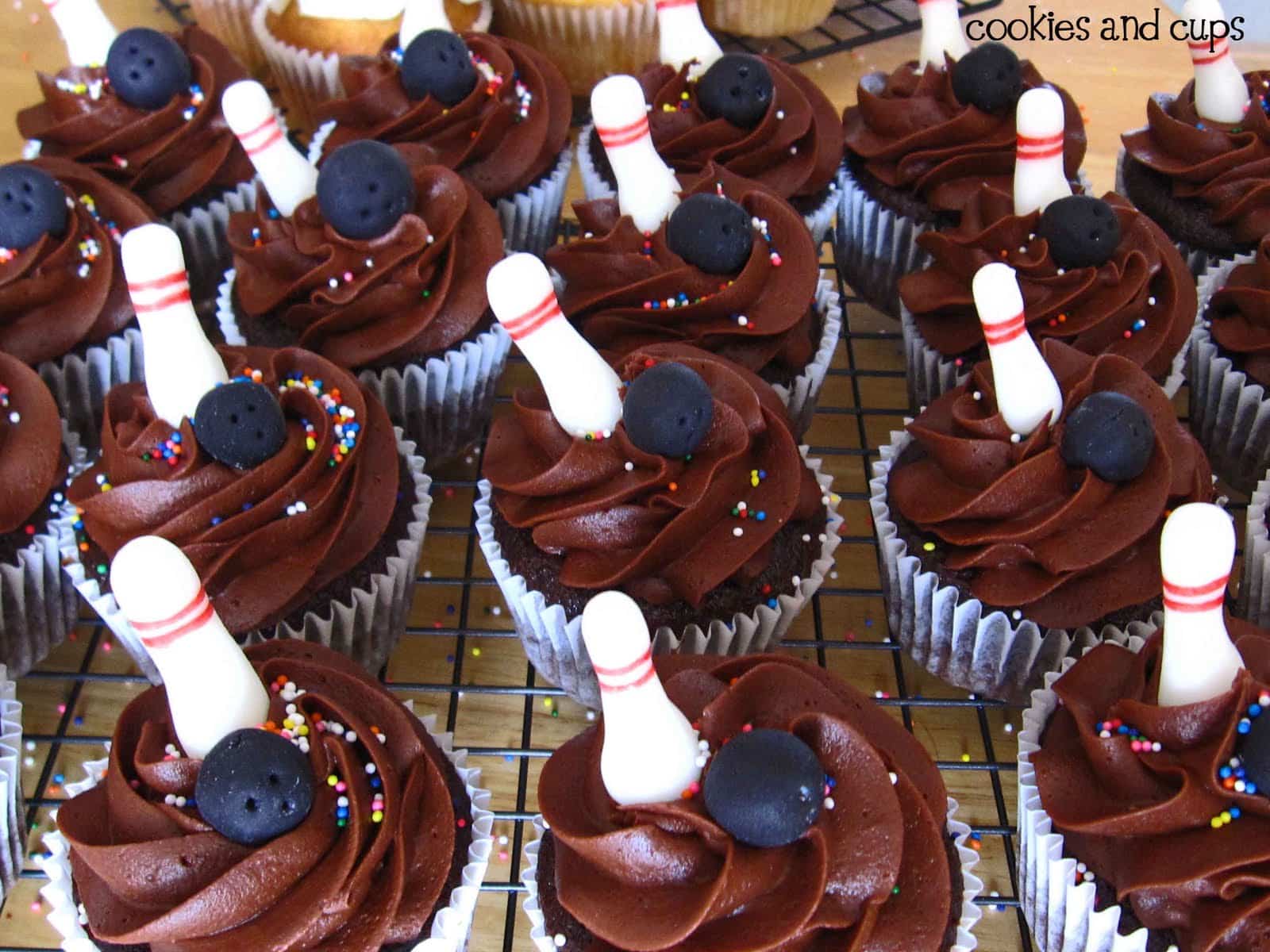 Close-up of chocolate cupcakes with bowling pin decorations