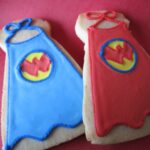 Overhead view of two Wonder Woman cape decorated cookies