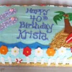Overhead view of a beach-themed 40th birthday sheet cake