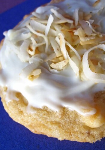 Close-up view of a Coconut Lime cookie with frosting and shredded coconut