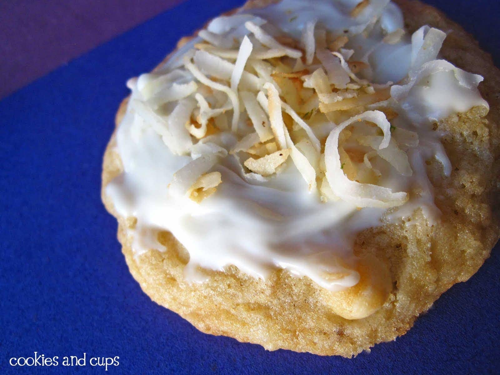 Close-up view of a Coconut Lime cookie with frosting and shredded coconut
