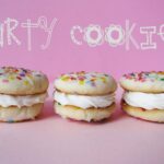 Three vanilla sandwich Party Cookies in a row