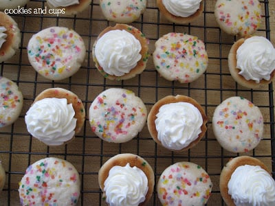 Frosted cookies with a swirl of frosting on a cooling rack