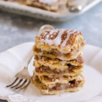 A stack of apple pie bars on a plate.
