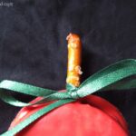 Close-up of an Apple Oreo Pop pretzel stem with green ribbon