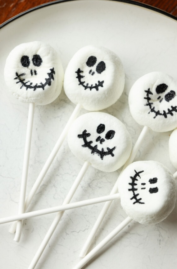 Marshmallows on a lollipop stick with black skeleton faces drawn on