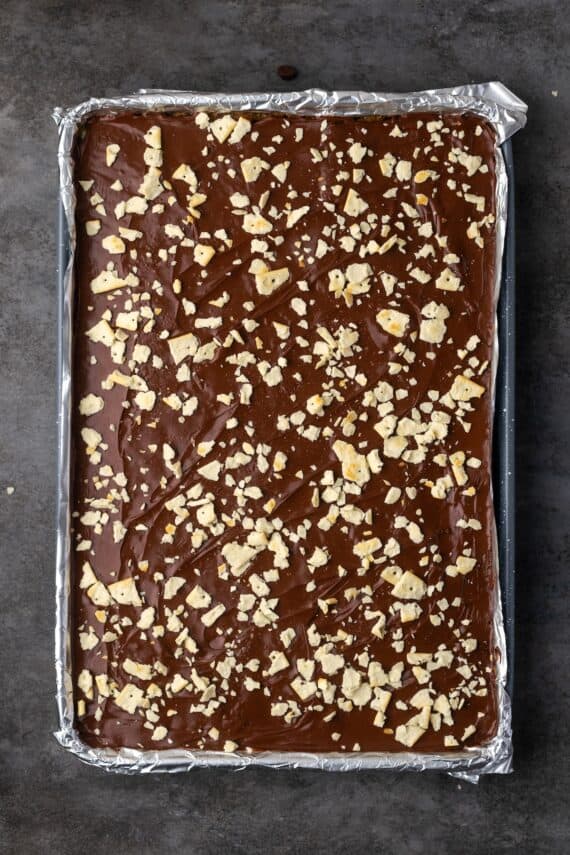 Overhead view of saltine toffee in a large lined baking sheet.