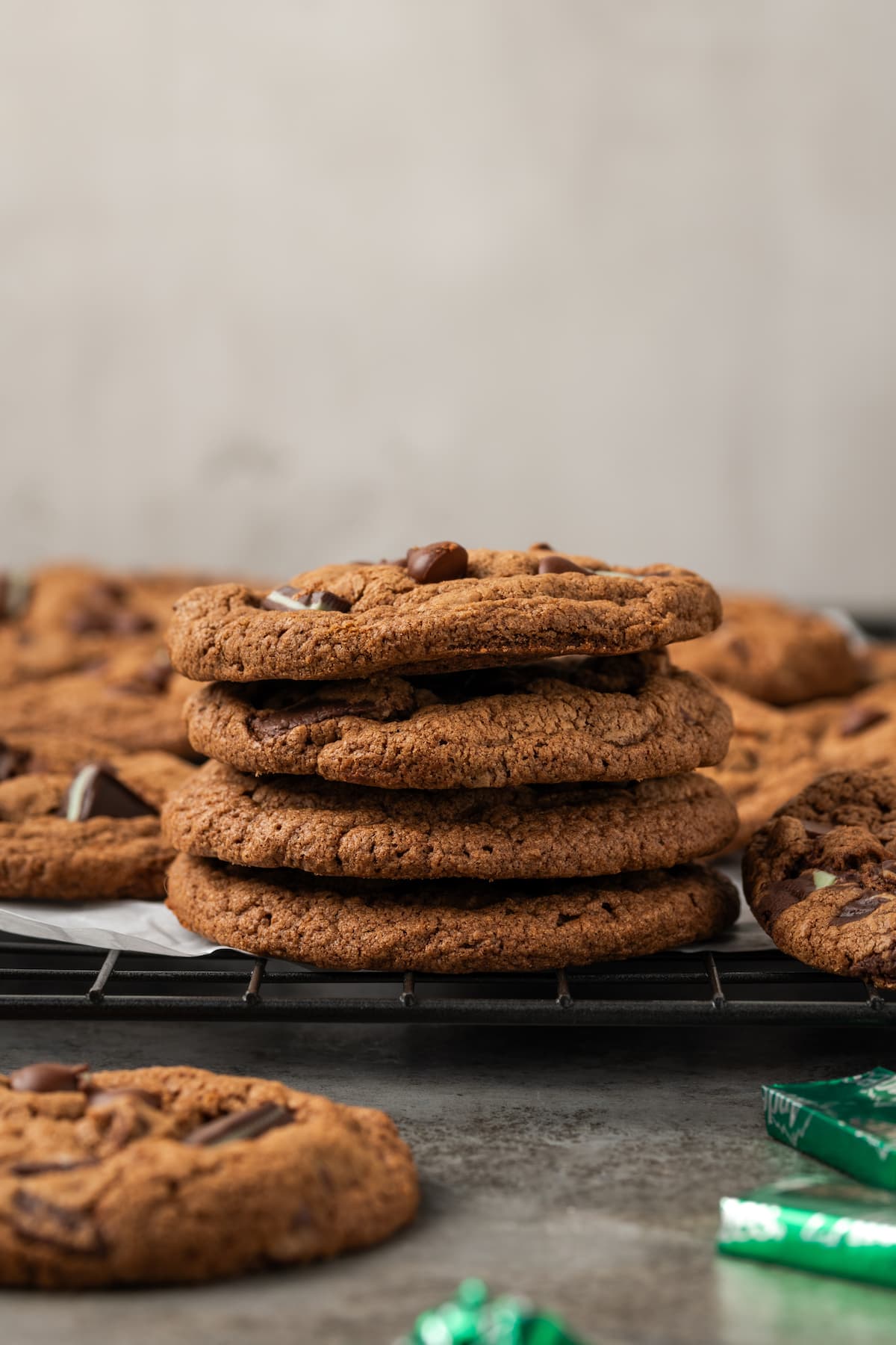 A stack of double chocolate mint cookies on a wire rack.