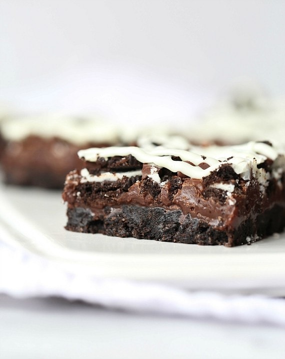 Triple Chocolate Oreo Bars...A creamy fudge layer that sits on top of a crunchy Oreo crust, topped with chocolate chips, MORE Oreos and white chocolate!