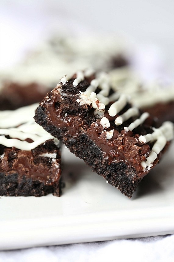 Triple Chocolate Oreo Bars...A creamy fudge layer that sits on top of a crunchy Oreo crust, topped with chocolate chips, MORE Oreos and white chocolate!