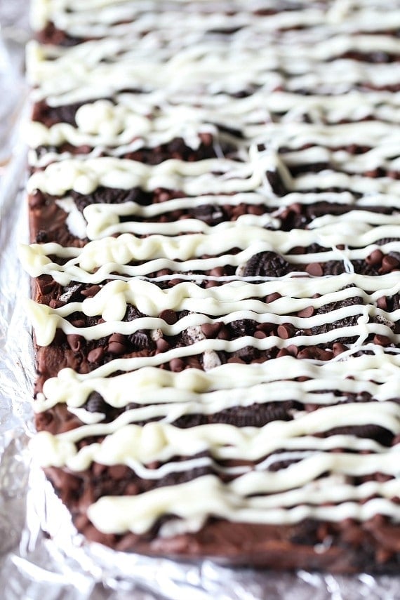 Triple Chocolate Oreo Bars...A creamy fudge layer that sits on top of a crunchy Oreo crust, topped with chocolate chips, MORE Oreos and white chocolate!