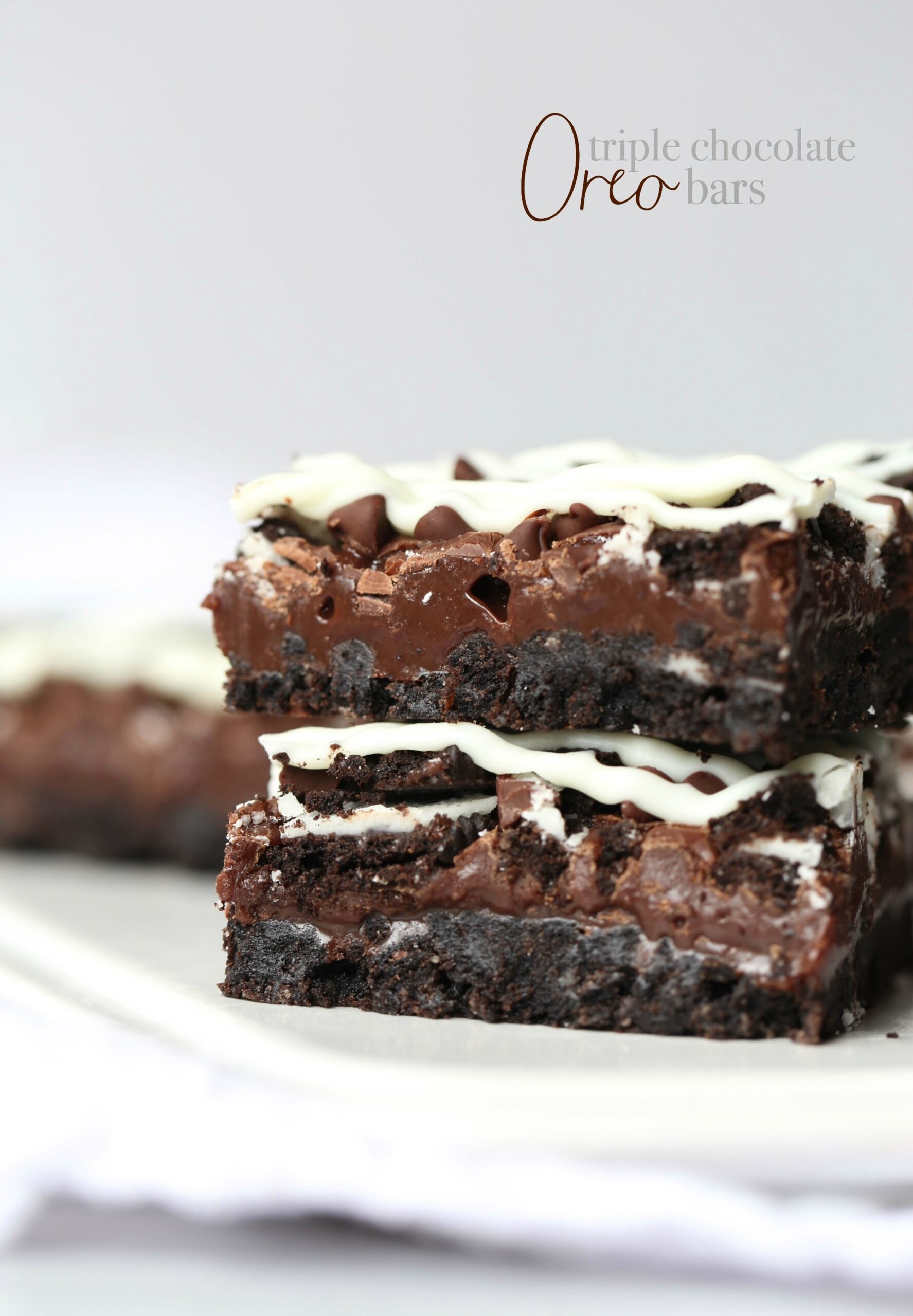 Triple Chocolate Oreo Bars...A creamy fudge layer that sits on top of a crunchy Oreo crust, topped with chocolate chips, MORE Oreos and white chocolate!