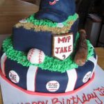 A navy multi-layer baseball themed cake with a hat on top.