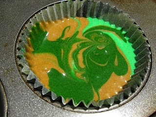 Close-up of marbled camo cupcake batter in a muffin tin