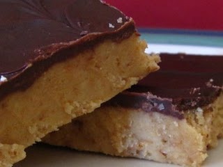 A Close-Up Shot of Two Chocolate Peanut Butter Dessert Bars on a Blue-Rimmed Plate