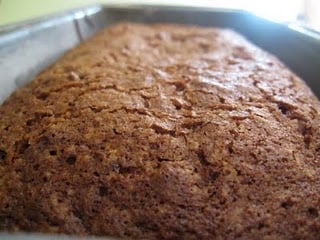 Close up of a baked zucchini bread in a metal loaf pan.