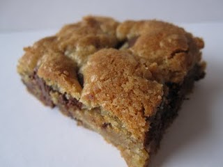 A chocolate chip cookie bar on a white surface.