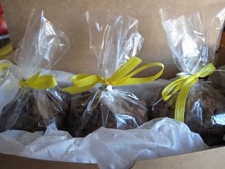 Chocolate cookies wrapped up in cellophane with yellow bows.