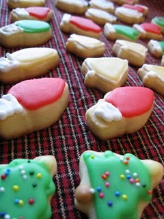 A Lineup of Assorted Mini Sugar Cookies with Decorations of Christmas Lights, Christmas Trees and Christmas Bells